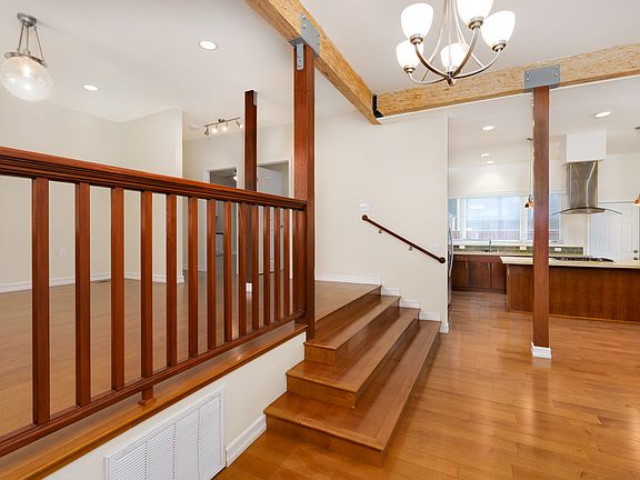 high ceilings, beautiful wooden beams, entry with open kitchen.