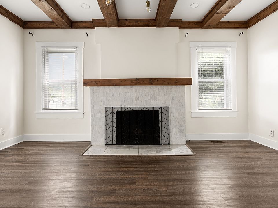 Living room with fireplace and exposed beams