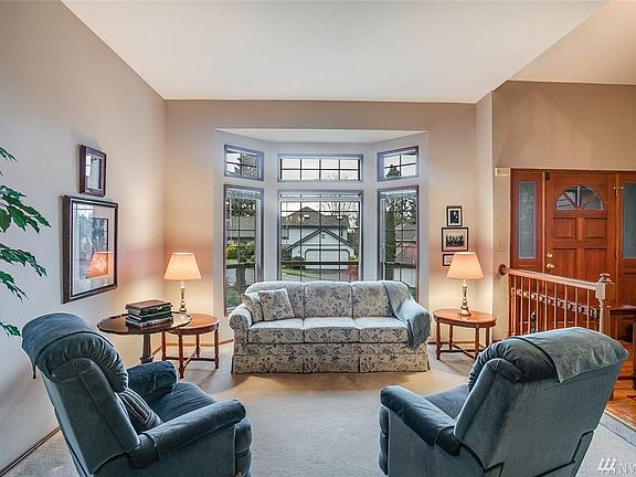 This inviting living room boasts a large bay window and open sight lines to the formal dining room. 