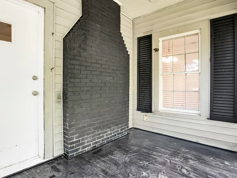 Front porch sitting area and front door.