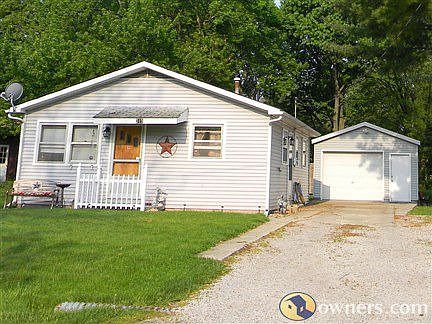 Front of house with view of garage