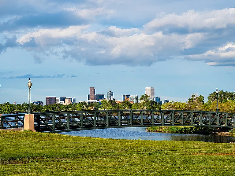 Experience urban tranquility with this stunning view of the skyline and serene river.