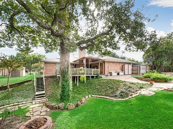 Expansive deck overlooking this lush backyard, perfect for morning coffee or just unwinding after a long day, you won't get a view like this anywhere else!