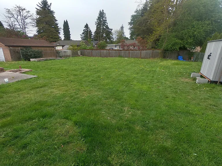 Huge fully fenced yard with storage shed and herb garden