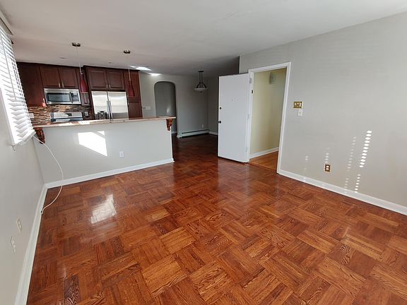 Apartment entrance into natural light filled living room