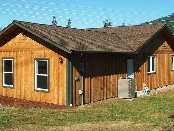 The NE side of the house. See the heat pump! Also an RV plug-in & waste dump!