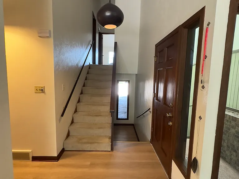 Main entry and stairs to second level (left) and stairs to basement (right)