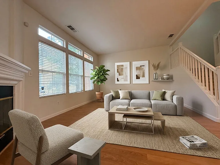 Living Room - Photo digitally staged for visual context. Swipe to see empty space!