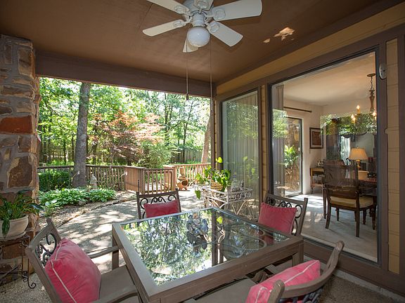 Dine alfresco in style! The spacious covered outdoor living area with ceiling fan overlooks the expansive deck and park-like backyard while offering comfortable respite from the elements.