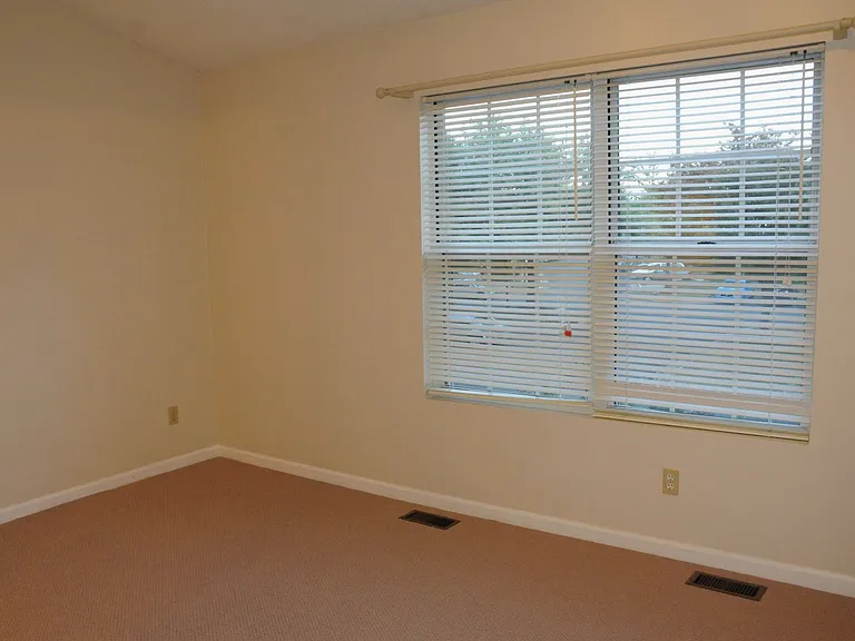 Second upstairs bedroom, with windows looking out on the front yard.