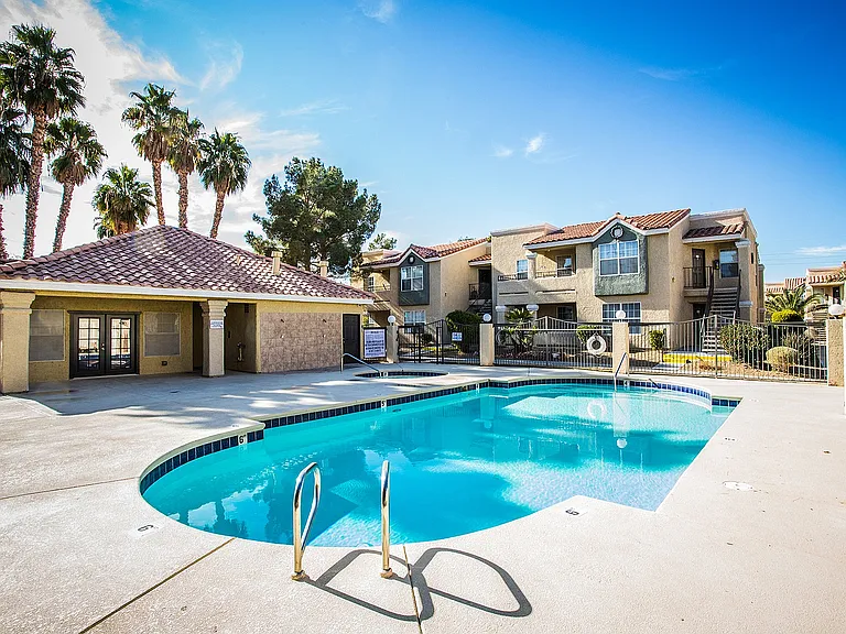 Experience luxury living with a refreshing pool and beautiful surroundings.