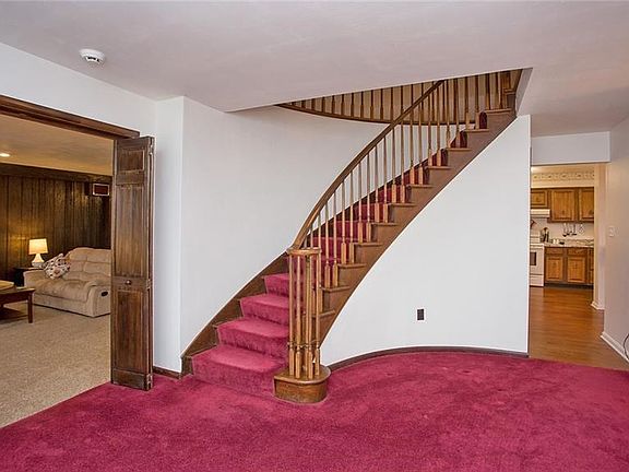 At the entry of the home is the unique spiral staircase which leads upstairs to five large bedrooms.