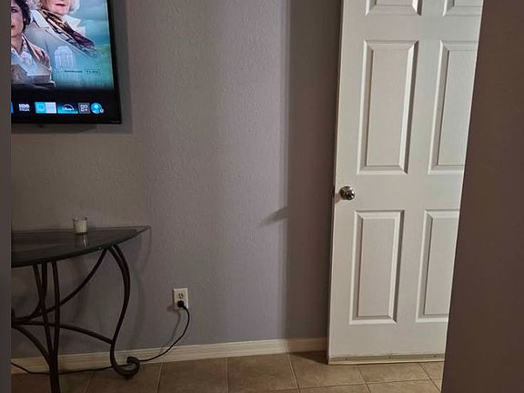 Entrance to Private Living Room Space with large TV and Coffee Pot