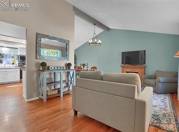 Entry into living room with gorgeous hardwood floors and vaulted ceiling.