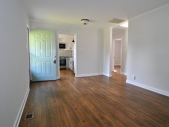 Living space with hardwood floors and fresh paint