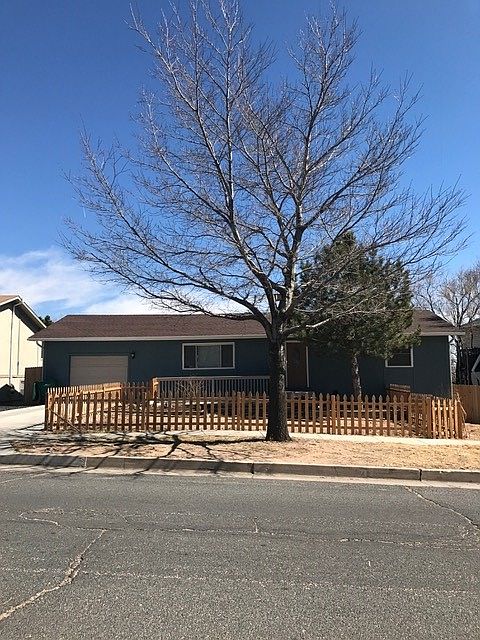 Front of the property with large fenced yard
