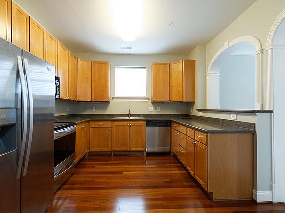 Kitchen with stainless steel appliances, solid surface countertops and new stainless steel sink