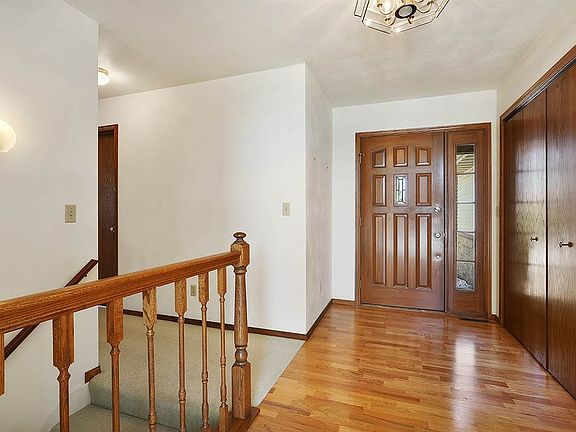 Large entry way with coat closet and wood flooring
