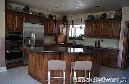 Kitchen with cherrywood cabinets, granite countertops, and built in appliances