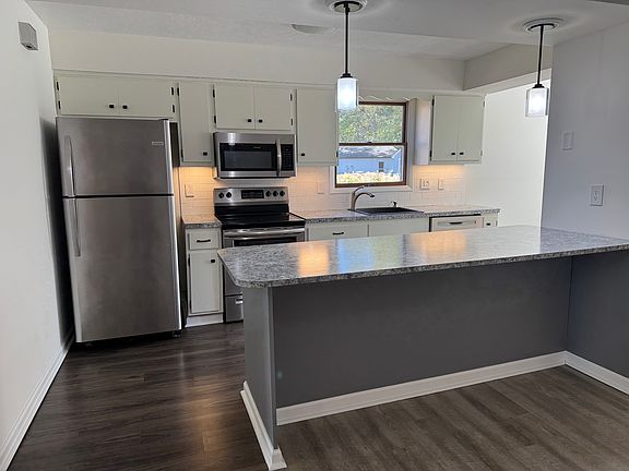 Peninsula countertop has 2 overhangs for seating options on both sides