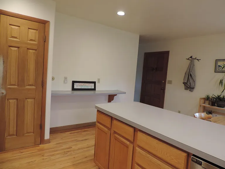 The pantry is on the left and the front door is to the right.