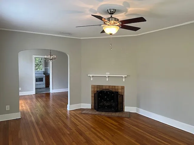 Large living room with fireplace. Arch to dining room.