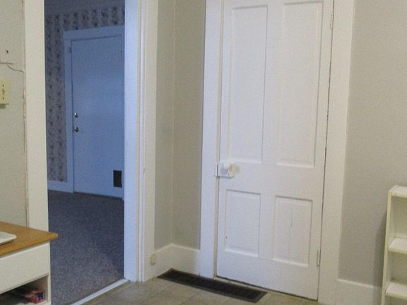 pantry door in kitchen and entrance to middle room which could be used for bedroom/living room.