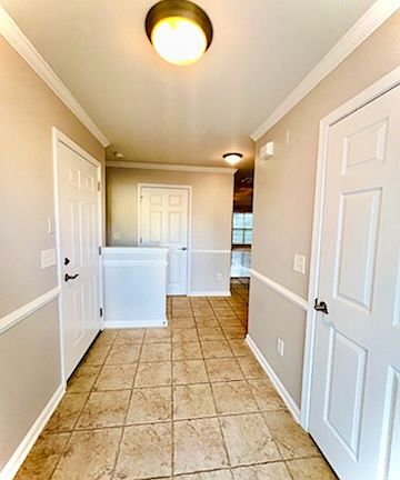 Foyer entrance with coat closet and garage entry door.