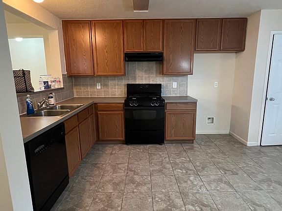 Kitchen view. Appliances are dishwasher, garbage disposal and gas stove.
