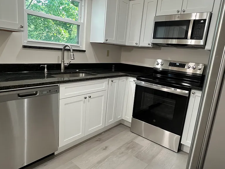 Left side of *brand new* kitchen! Sink has garbage disposal.