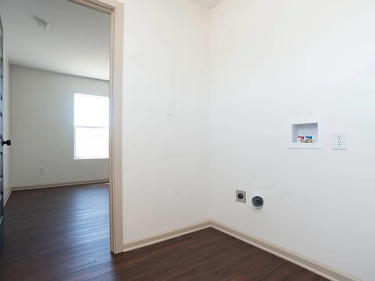 Laundry area in upstairs hallway. Top load washer and dryer have been added.