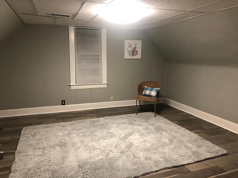 Living room with laminate gray flooring. freshly painted.