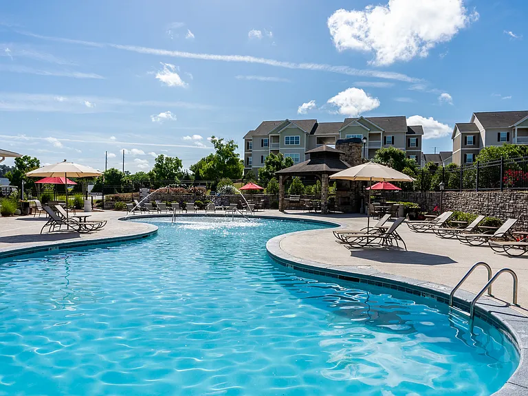 Resort-style swimming pool with lounge chairs