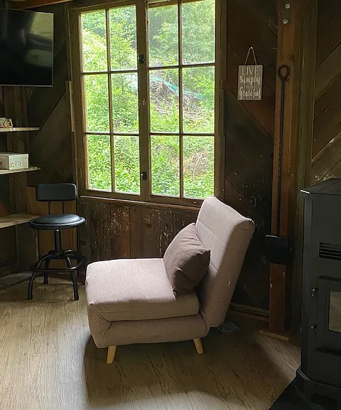 TV is mounted in the corner, window opens for a cool summer breeze!