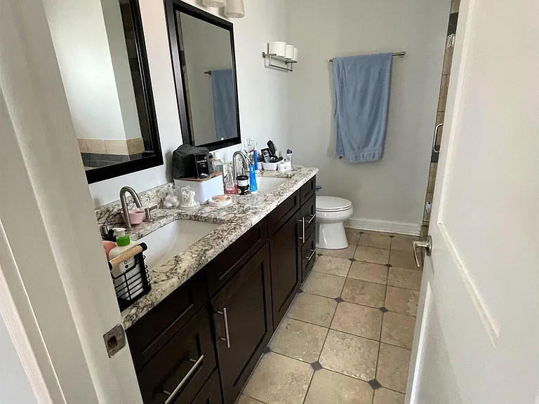 Primary bathroom with jet tub, shower; two sinks; window and natural light