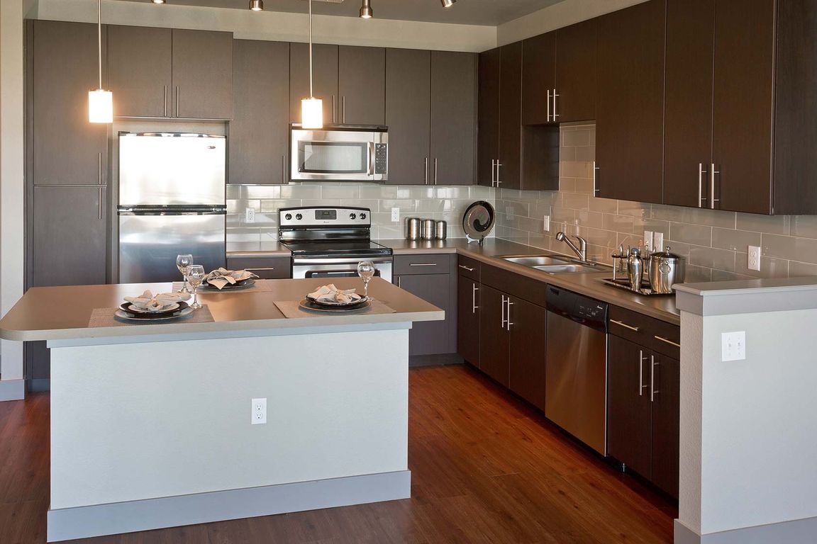 Kitchens with granite countertops and wood flooring