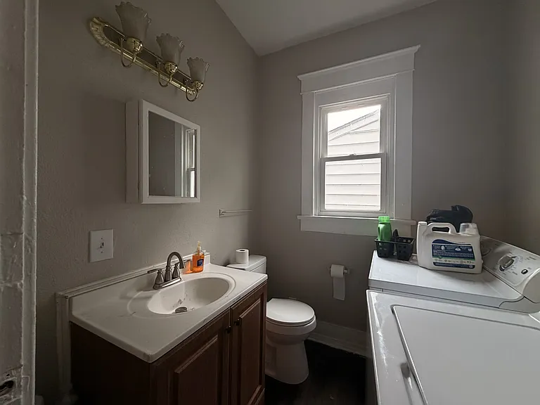 main level half bathroom with washer and dryer