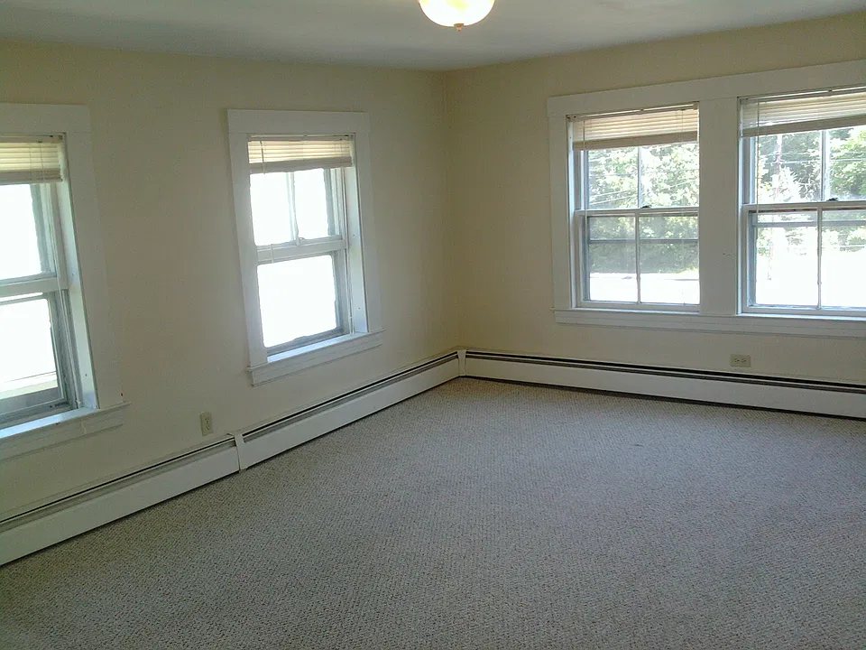 Living room has new carpet and windows and fresh paint.