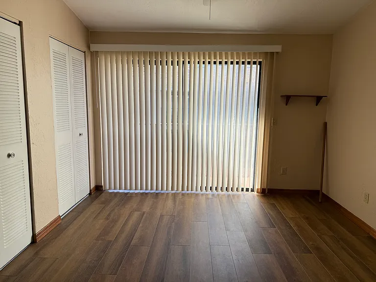 Bed room on the back with a balcony