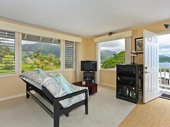 Living room area w/ large picture windows (furniture not included)