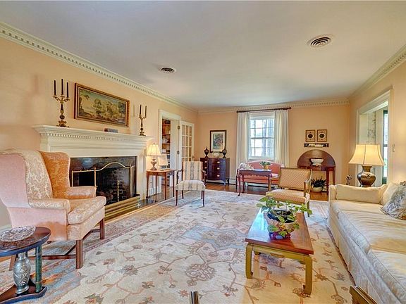 Formal living room with gas fireplace and dental crown molding