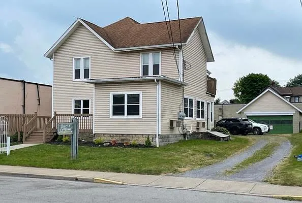 The properties driveway leads to private off street parking for tenets in the rear.