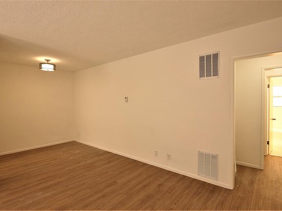 Living room has attached dining area.