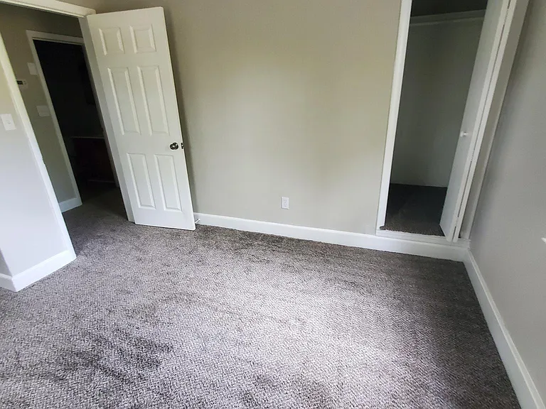 Large bedroom with view of small closet area