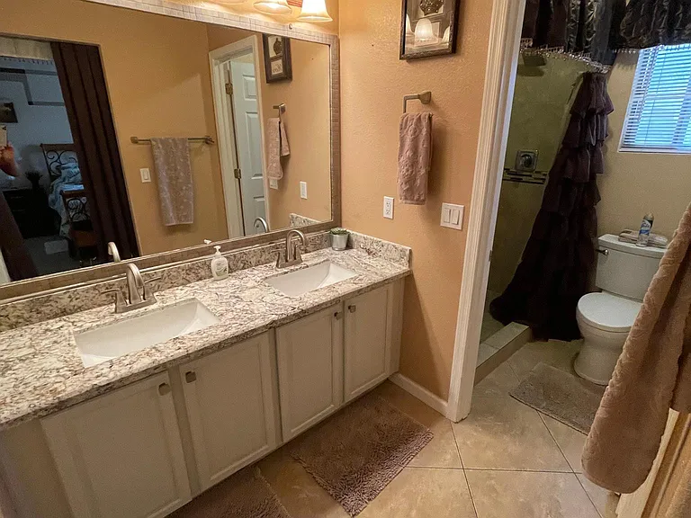 Master ensuite with double sinks and private WALK-IN shower and new ADA toilets throughout plus 3 storage areas: WALK-IN closet plus master side closet plus armoire!