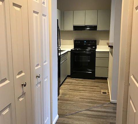 Hallway from bathroom and bedroom, newer wood engineered flooring, right has more closet space. dishwasher not shown.