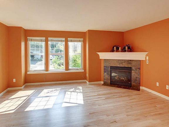 living room with gas fireplace and hardwood floors throughout the main level