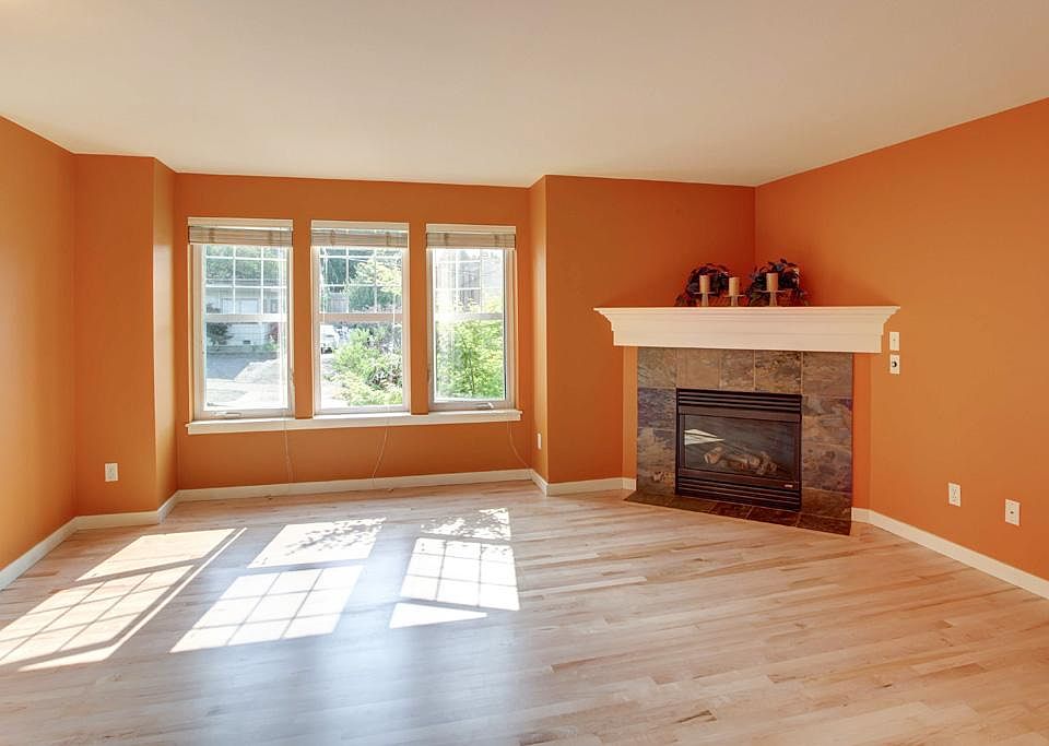 living room with gas fireplace and hardwood floors throughout the main level