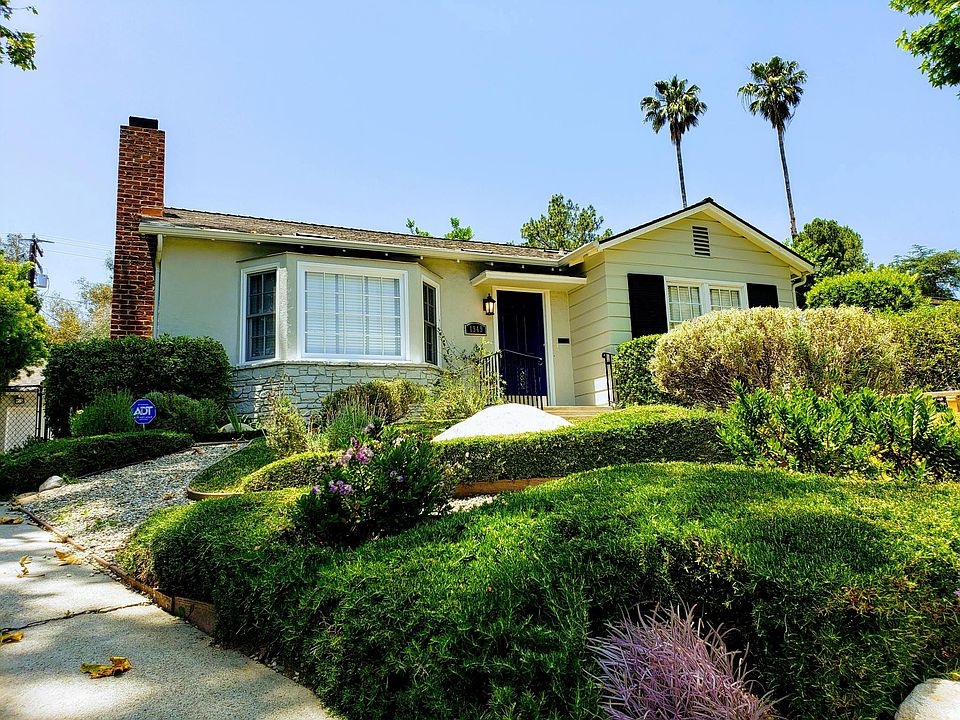 Sunny curbside view in tree-lined neighborhood