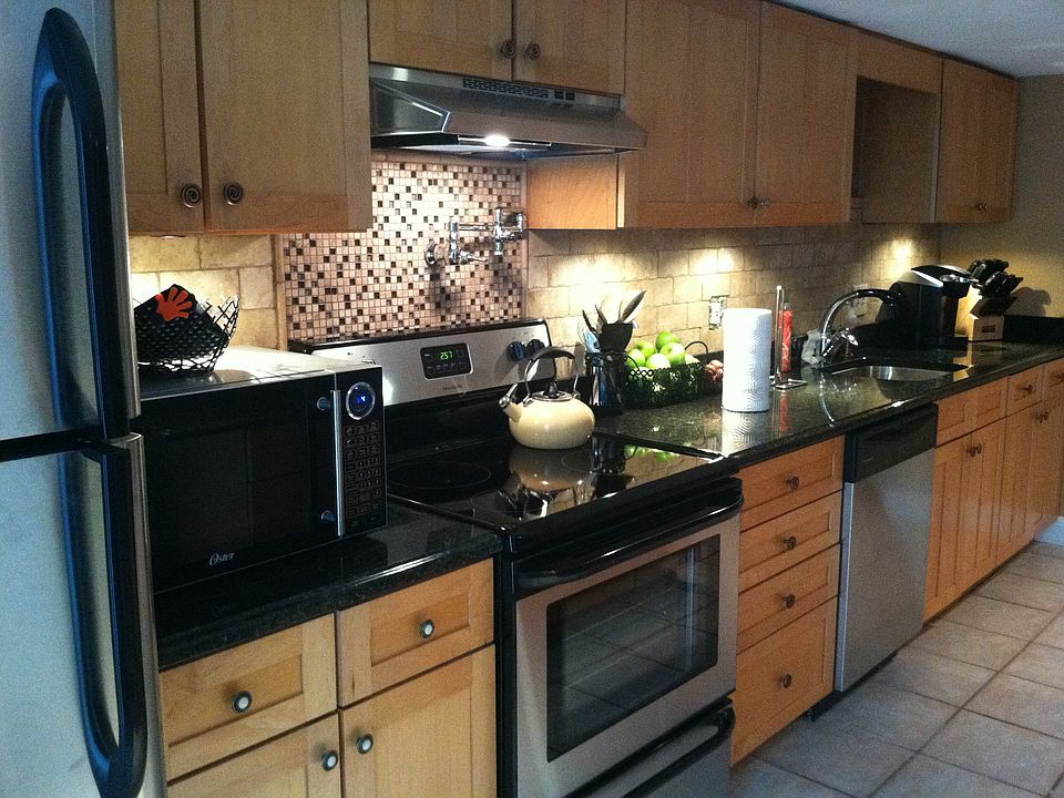Stove faucet, granite, tile back splash. 